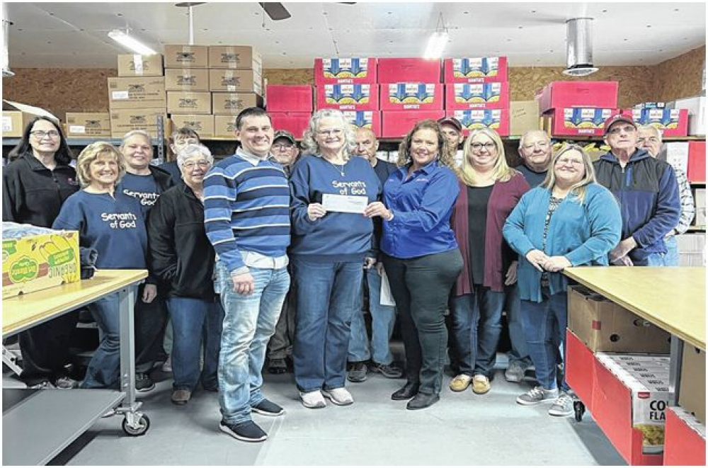 Pictured in front, from left, are Felman Plant Manager Vitaliy Anosov, Food Pantry Director Vicky Nazarewycz, Felman Controller Diane Hill, Felman Administrative Assistant April Nazarewycz, and Felman Purchasing Agent Phyllis Flowers. Also shown are several of the food pantry volunteers.